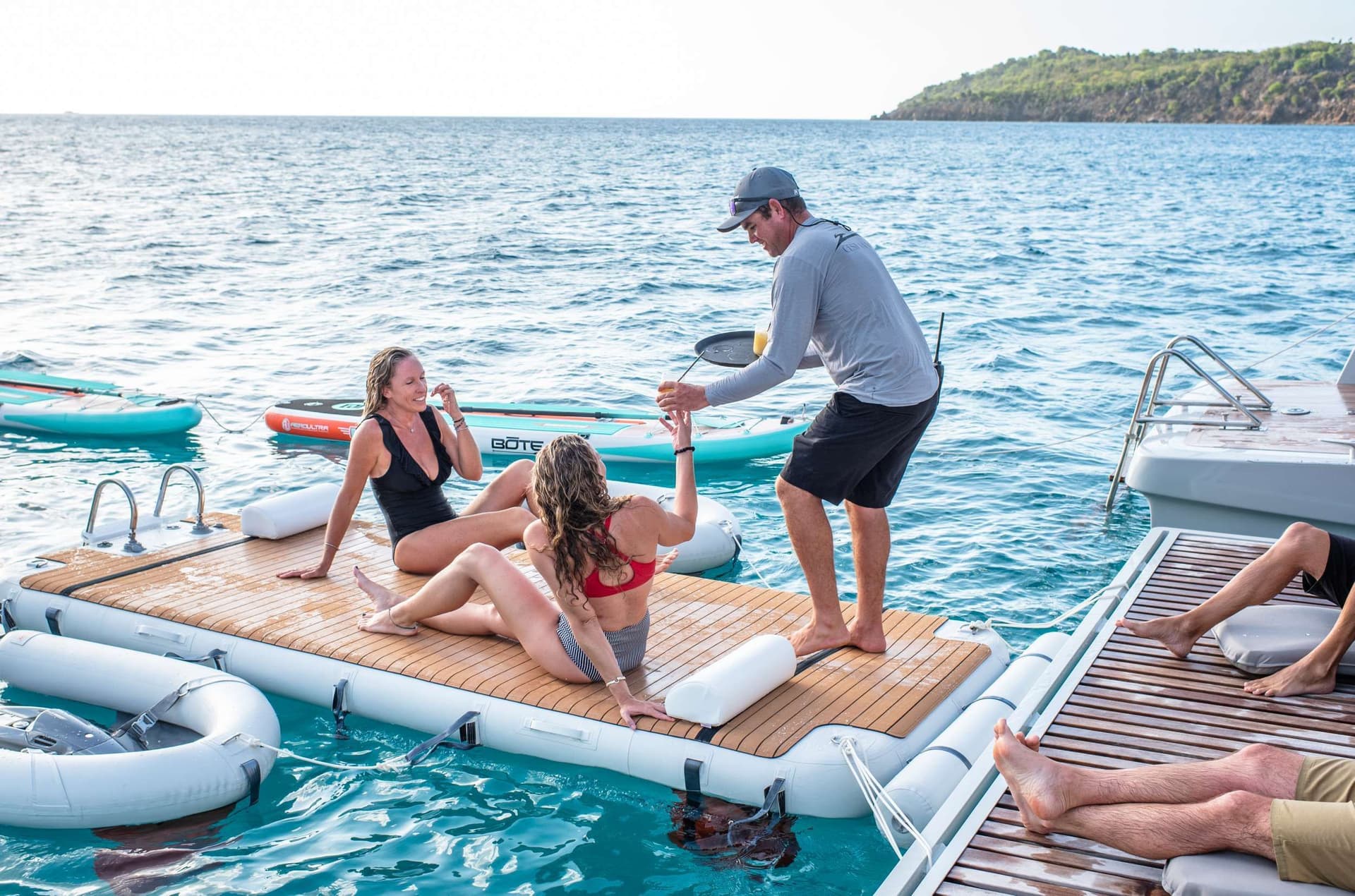 Captain Robbie Handing out drinks on a crewed catamaran in the BVI.jpeg